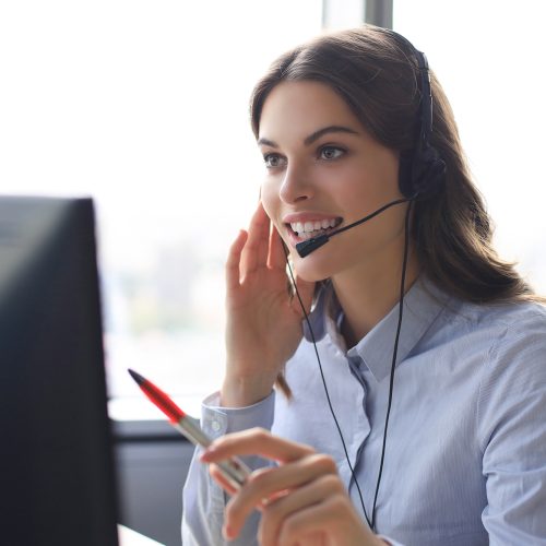 Woman customer support operator with headset and smiling